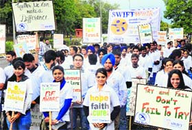 Students of the Swift Group of Colleges take out a cancer awareness rally at Sector 9 in Chandigarh on Monday