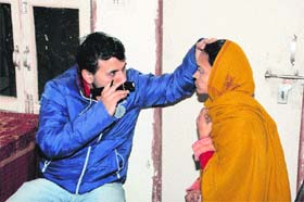 A doctor checks the eyesight of a patient at the free eye and ENT check-up camp organised by the Nar Narayan Sewa Samiti at Shiv Mandir Dharamshala, Shahabad Markanda