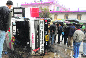 Passers-by gather at the accident site in Sundernagar on Monday. 
