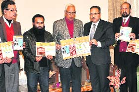 Governor NN Vohra releases a brochure on dos and donts for the Amarnath yatra, in Jammu on Monday