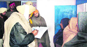 Policemen at the house where the elderly couple was attacked by their son near Shahkot in Jalandhar on Monday.