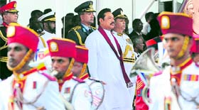 Sri Lankan President Mahinda Rajapakse (C) watches a military parade during the country's 65th Independence Day celebrations in Trincomalee on Monday.