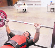 Ramandeep S Bajwa of PU campus, Chandigarh, lifts a weight during the final match of the PU Inter-College Power-Lifting (Men) Tournament at the PU Gymnasium Hall in Chandigarh on Tuesday.