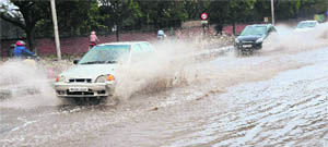 Vehicles pass through a waterlogged road dividing Sectors 32 and 46 after rain in Chandigarh on Tuesday. 