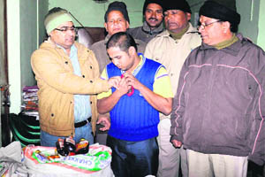 Officials of the Excise Department with the man arrested for ferrying illegal liquor in Haridwar on Tuesday. 
