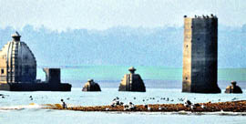 Old temples emerge out of the Pong Dam lake as water recedes during winter.