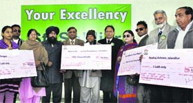 Representatives of St Soldier Group donate money during a charity show