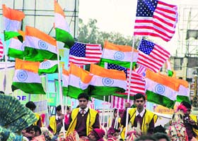 Schoolchildren participate during the Lions parade in Jalandhar, carrying flags of India and the USA, on Tuesday