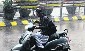 A schoolgirl gets drenched in heavy rain while going to home after school on Tuesday