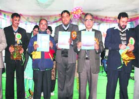 Minister for Agriculture Ghulam Hassan Mir releases magazine during a function in Jammu on Tuesday