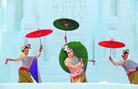 Snow maidens: Thai dancers perform in front of a sculpture of Thailands Wat Bendamabophit temple at the annual snow festival in Japan on Tuesday