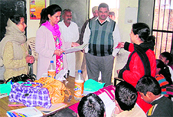 Chief Parliamentary Secretary Dr Navjot Kaur Sidhu checks the attendance register during a raid on a government elementary school in Amritsar on Wednesday
