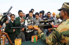 An Army jawan explains the working of a gun to students