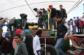 Students climbed atop a tank on display at the Indian Army stall at the festival