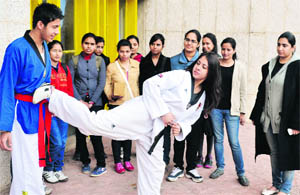 A martial arts player gives a demonstration during a self-defence workshop at Panjab University in Chandigarh on Wednesday. 
