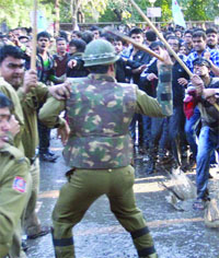 Police uses water cannons and lathis to disperse the activists of AISA who were protesting outside Sri Ram College of Commerce against the visit of Gujarat Chief Minister Narendra Modi in New Delhi on Wednesday. 