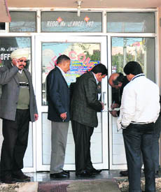 Health department officials seal a nursing home at Gandhi Nagar in Jammu on Wednesday. 