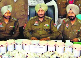 Police officials with the seized contraband in Tarn Taran on Wednesday
