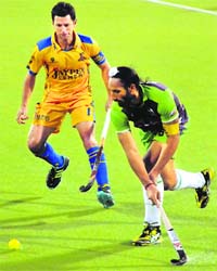 Punjab and Dehli players in action during their Hockey India League match in Jalandhar on Tuesday