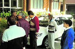 Court officials and HUDA employees argue over the attachment of HUDA Chief Administrator DPS Nagal's car in Panchkula on Thursday