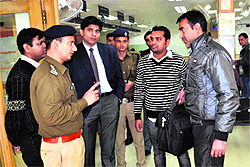 Circle Officer Rajesh Bhatt talks to bank officials regarding security measures in Haridwar on Thursday