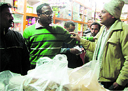 Dehradun District Magistrate BVRC Purshottam inspects a shop as part of an anti-polythene campagn in Dehradun on Thursday