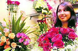 A girl buys flowers on Rose Day as part of the Valentine week celebrations in Dehradun on Thursday