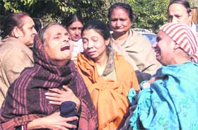 Relatives of cameraman Naresh (Bhutto) wail in Jalandhar on Thursday