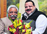 Minister for Planning Ajay Sadhotra greets provincial president of the National Conference Devender Singh Rana in Jammu on Thursday