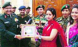 Vice-Chief of Army Staff Lt Gen SK Singh presents a memento to a teacher from J-K and participant of the national integration tour Watan Ki Sair in New Delhi on Thursday