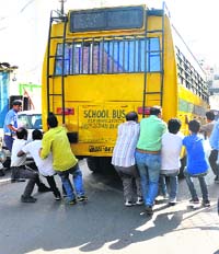 A file photo of a bus belonging to the Delhi Public School being stopped by passersby in October last year. As many as 40 students of the school on board the bus were rescued in the incident.
