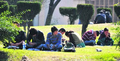 Students enjoy sunshine on Jammu University campus on Thursday