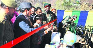 A students inaugurates a library at Sathra in Mandi on Thursday.
