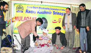 Prof Ghulam Nabi Firaq being honoured by Radio Kashmir in Srinagar on Thursday. 