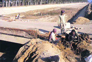 Workers carry out repair work at Old Tibba Bridge in Sahnewal on Thursday. 