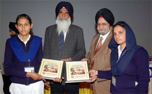 The winners receive their prizes at the inter-college youth festival held at Adesh University.