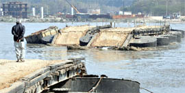 The flash flood washes away a pontoon bridge over Yamuna in New Delhi on Friday.