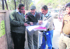 Dehradun District Magistrate BVRC Purushottam inspects the widening of the Raipur road in Dehradun on Friday. 