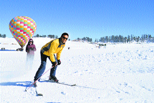 A tourist enjoys skiing at the ski resort in Gulmarg on Friday.
