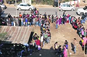 Applicants wait for their turn to submit forms outside the office of the Services Selection Board in Jammu on Friday.