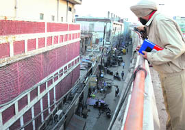 A policeman inspects the site where a 15-year-old boy died after falling froman elevated road, in Ludhiana on Friday.