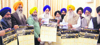 Akal Takht Jathedar Giani Gurbachan Singh (4th from L) releases the amended Nanakshahi Calendar in Amritsar on Friday. 