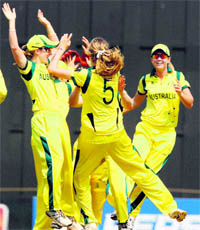 Australia team celebrates the fall of an England wicket on Friday.