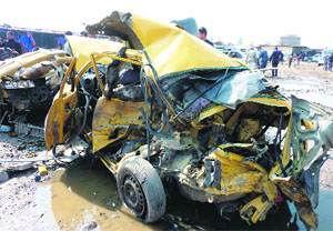A destroyed car at the scene of an explosion at the bird market in north Baghdad on Friday.
