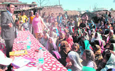 MH Khan, Secretary, Minorities Development, Uttarakhand government, intercates with villagers of Rampur Kalan in the Sahaspur block of Dehradun district on Saturday. 