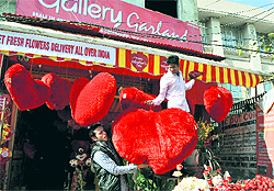A shopkeeper decorates his shop ahead of Valentine Day in Jammu on Saturday