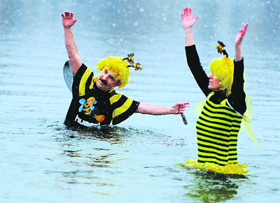 Dressed up ice swimmers stand in the Oranke sea in Berlin. Ice bathers from 17 clubs in the German capital enjoyed the cold water.