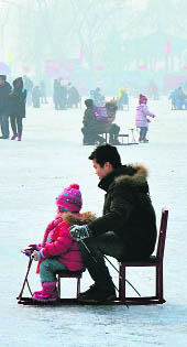 Chinese holidaymakers ride sleds on the frozen Houhai Lake in Beijing.
