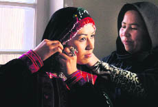 A model prepares prior to a fashion show in Kabul on Friday, as part of efforts to empower women by breaking barriers in this highly conservative society. 