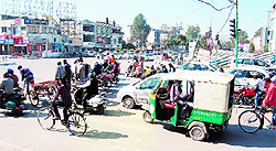 With zebra crossing not visible, vehicles leave no space for pedestrians to cross the road near Lawrence road chowk in Amritsar